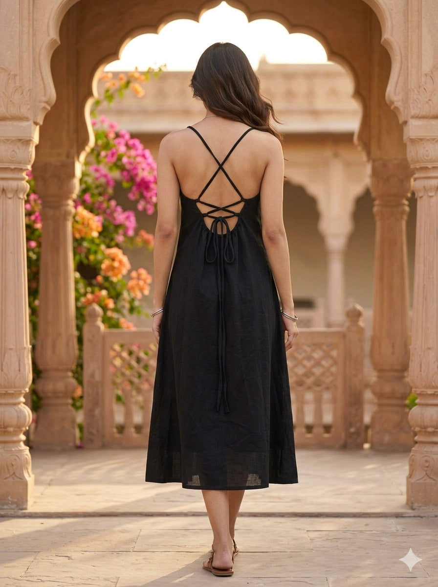Full back view of the black A-line midi dress showing the open back and centre tie detail