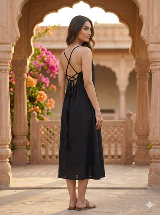 Criss-cross open back of the black khadi midi dress with adjustable tie, seen over the shoulder
