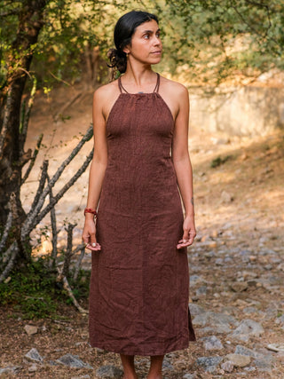 Side view of the Adina Maxi Dress, solid brown cotton halter maxi with a free-size A-line drape on a model