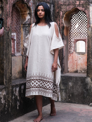 Chandra Kaftan full length front view under a Rajasthan arch, natural cotton jute kaftan with brown tribal hem border