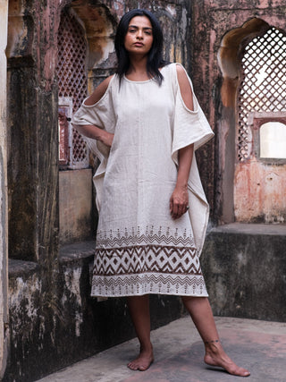 Chandra Kaftan three quarter front view by a jaali window, natural cotton jute kaftan with cold shoulder cut outs