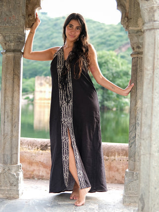 Black Devi Maxi Dress with printed panel, full length at stone arch