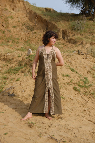 Earthy brown Devi Maxi Dress full length on desert slope