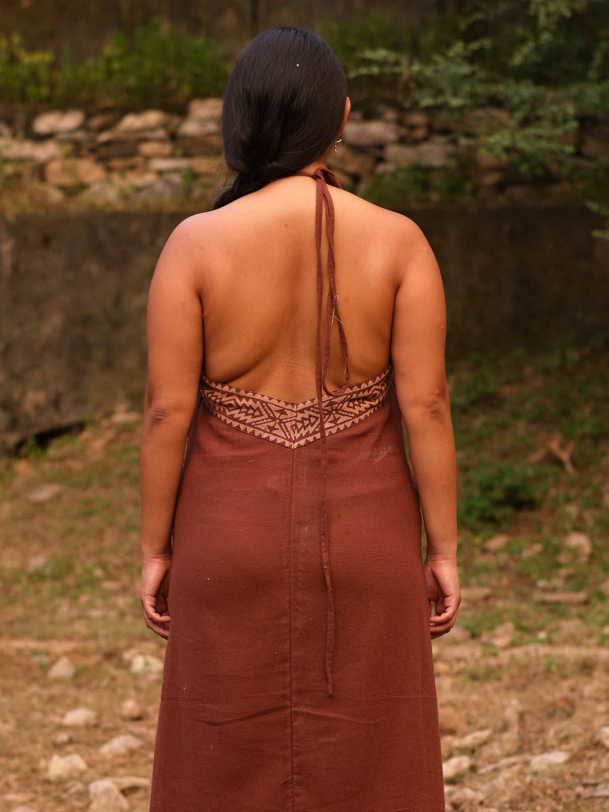 Rust brown Devi Maxi Dress back with strappy halter detail, outdoors