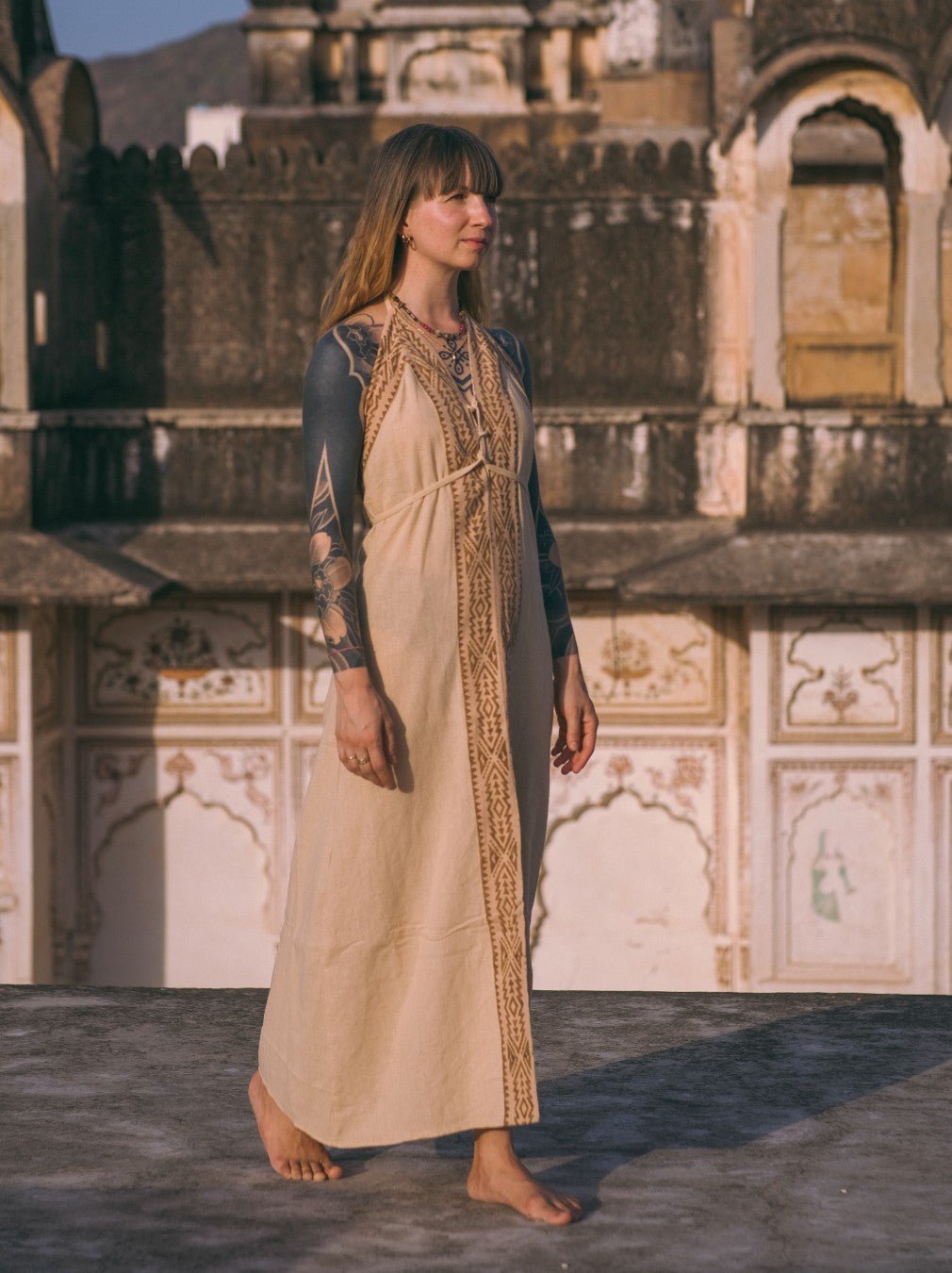 Beige Devi Maxi Dress with layered black top, full length at heritage complex
