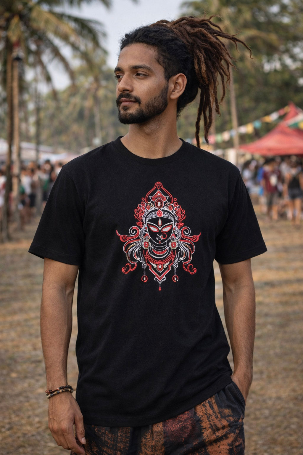 Close-up of the Devi UV reactive print, magenta cyan and purple deity line-art on a black tee