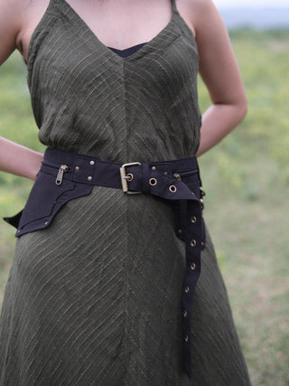 Front view of the Dhaar Festival Bag on a model, black cotton waist bag with buckle belt and zip and flap pockets