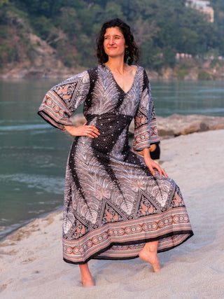 Dhaara printed cotton maxi dress, full length on a barefoot model showing the paisley hem border
