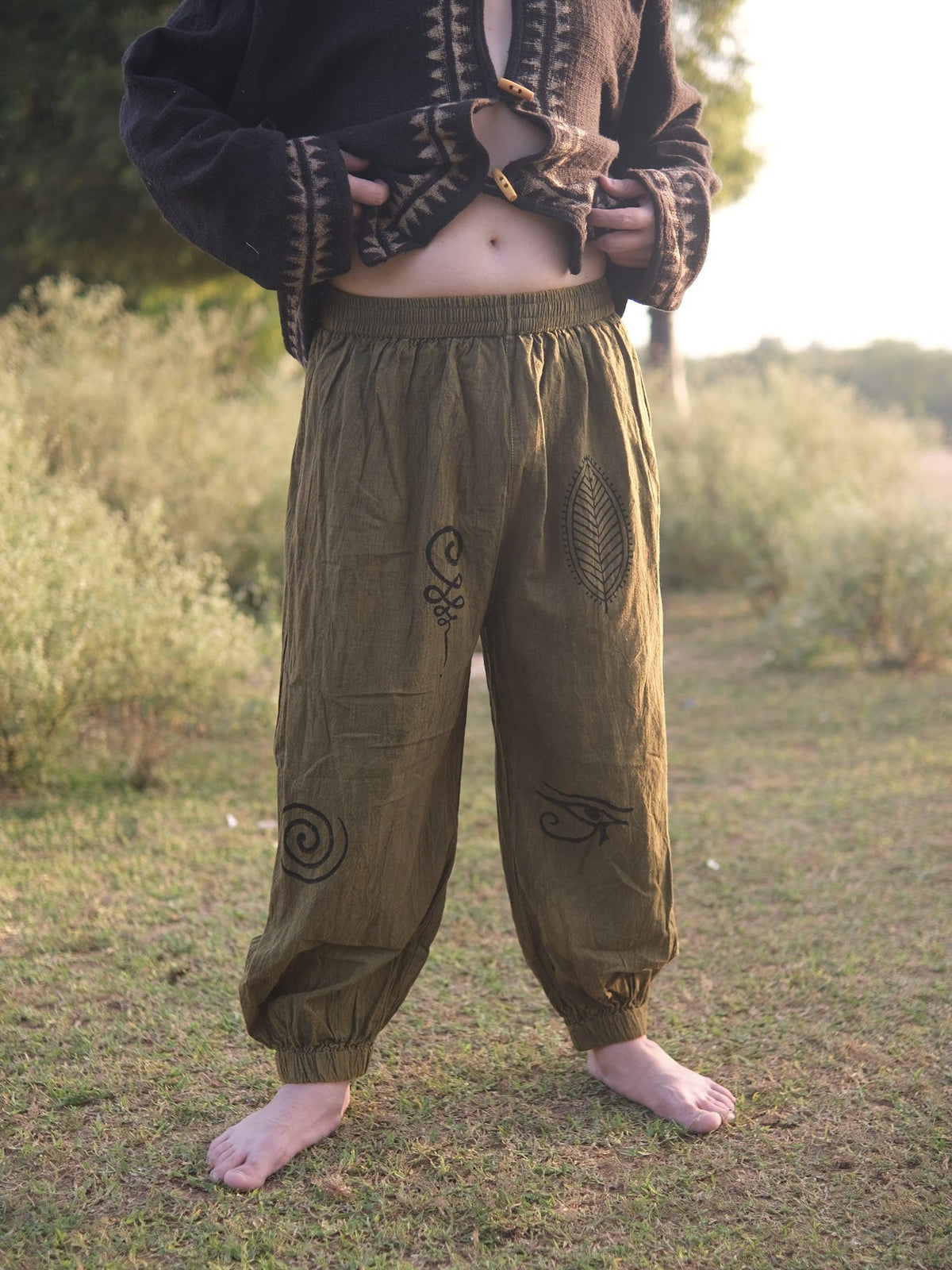 Wide-leg olive green harem pants with elasticated waist, styled for a bohemian look