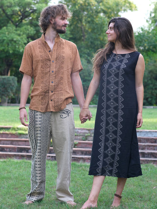 Ekakshi Maxi Dress in black cotton worn by a model standing with her partner on a lawn