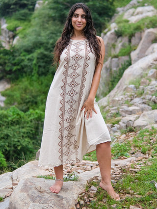 Ekakshi Maxi Dress in natural cotton, model walking and lifting the skirt to show the block print panel