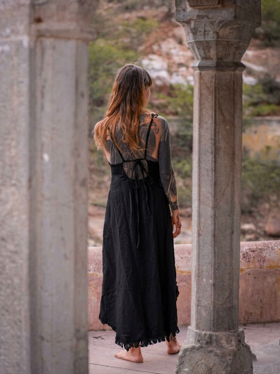 Back view of black halter maxi dress with criss-cross ties, stone arches
