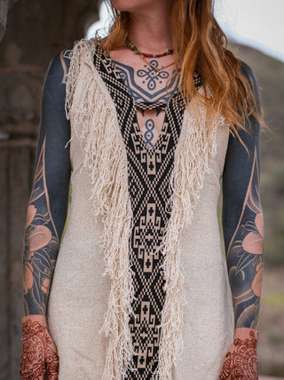 Detailed view of cream Elementos dress fringe and geometric tribal panel
