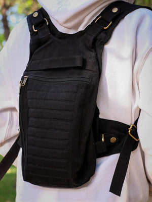 Close crop of the black Enigma Ninja Bag worn on the chest, horizontal stitching and zipper pulls in frame
