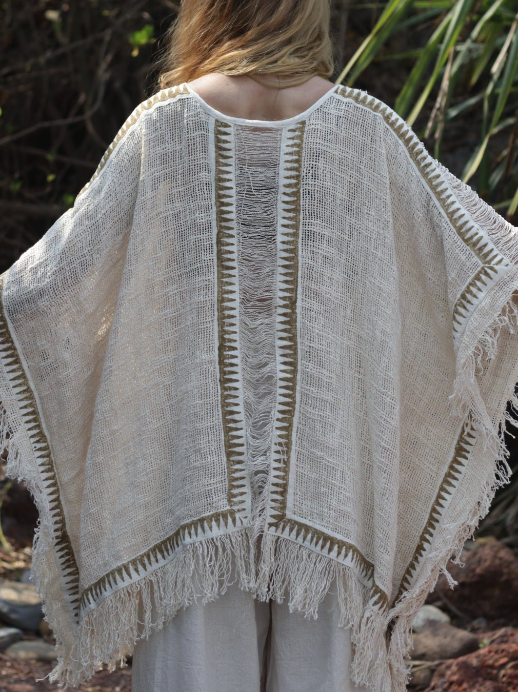 Esha Kaftan in natural cream, back view of the fringed open-knit kaftan on a model