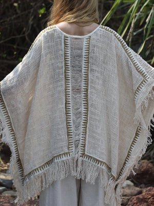 Esha Kaftan in natural cream, back view of the fringed open-knit kaftan on a model
