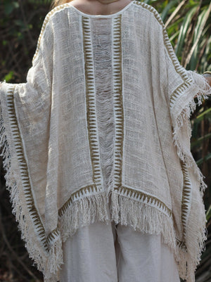 Esha Kaftan in natural cream, close back view of the ladder-stitch knit and fringe hem