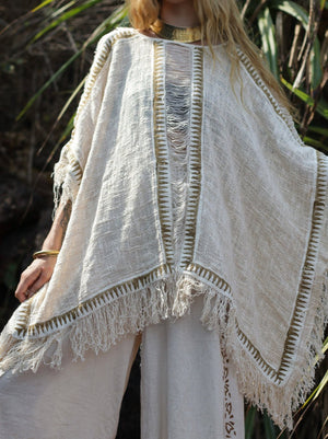 Esha Kaftan in natural cream, back view of the open-knit poncho with woven zigzag trim