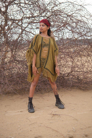 Esha Kaftan in olive green, fringed kaftan worn over shorts with ankle boots
