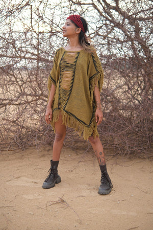 Esha Kaftan in olive green, side view of the fringed open-knit kaftan worn over shorts