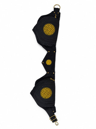 The Mystic Waist Belt, featuring a black fabric strap adorned with three circular yellow embroidered patterns and accented with gold hardware, is displayed on a white background—making it a bold festival accessory that adds flair to any outfit.
