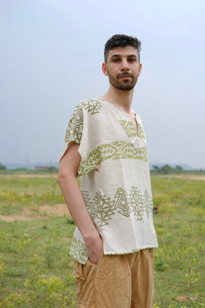 Gaayu Kurta front view on a male model with the olive geometric motif printed across the shoulder