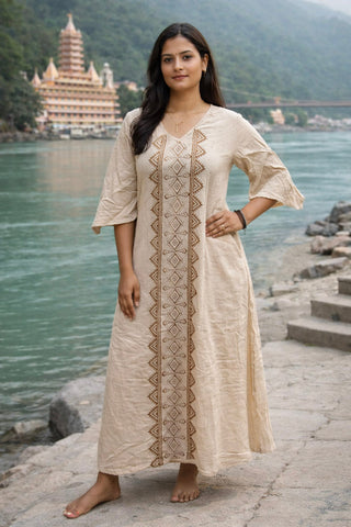Model standing with hand on hip in the beige Garga Dress, a free size hand block print cotton maxi for women