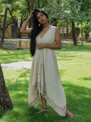 Gauri Maxi Dress in natural khadi cotton worn in a garden, sleeveless V-neck with adjustable tie waist