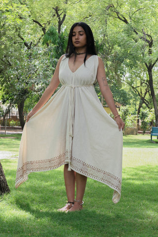 Model holding out the skirt of the Gauri Maxi Dress, natural khadi cotton with handblock border print