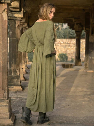 Olive green boho maxi dress back view in a temple corridor