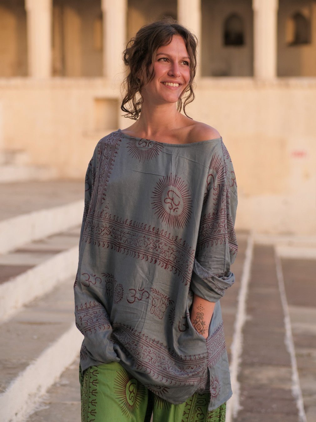 Pale grey blue Om print kurta, hand resting at the printed hem border band