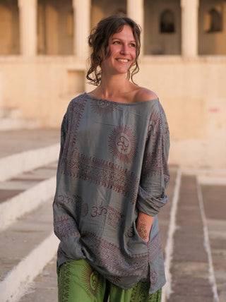 Pale grey blue Om print kurta, hand resting at the printed hem border band