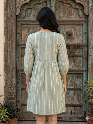 Back view of the Gulbaan Dress showing the gathered waist and flared striped cotton skirt