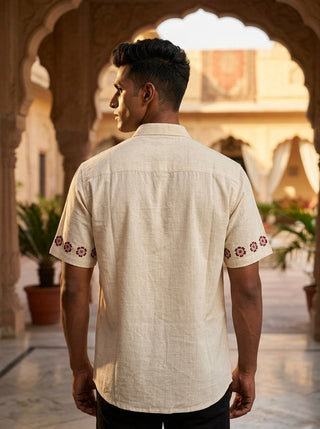 Back view of the Gulrez Shirt in natural cotton slub with an embroidered floral border on both short sleeves