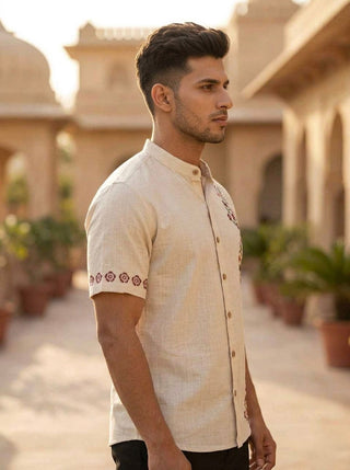 Side view of the Gulrez Shirt showing the mandarin collar and red floral embroidered sleeve border on cotton slub