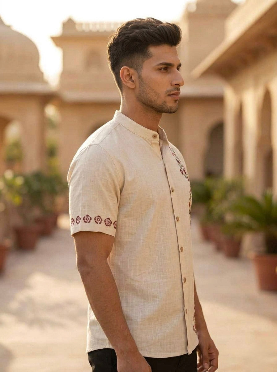 Side view of the Gulrez Shirt showing the mandarin collar and red floral embroidered sleeve border on cotton slub