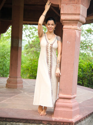 Idhika Dress in natural cream, front view of the block print cotton maxi under haveli arches