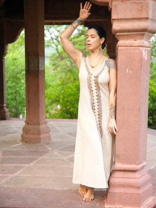 Idhika Dress in natural cream, front view of the cotton block print maxi beneath a carved archway
