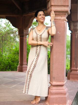Idhika Dress in natural cream, front view of the block print cotton maxi in a courtyard
