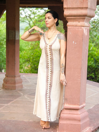 Idhika Dress in natural cream, side profile of the block print cotton maxi beneath a garden arch