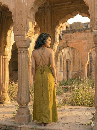 Idhika Dress in olive green, back view showing criss-cross straps and tie waist at a haveli