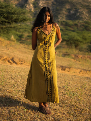 Idhika Dress in olive green, front view of the block print cotton maxi in a dry desert field
