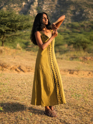 Idhika Dress in olive green, front view of the cotton block print maxi in a golden field