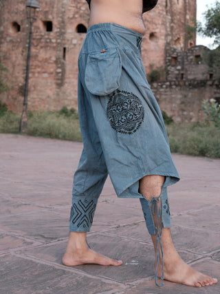 Kashf harem pants in blue cotton, side view showing the black ornamental leg motif and utility pocket