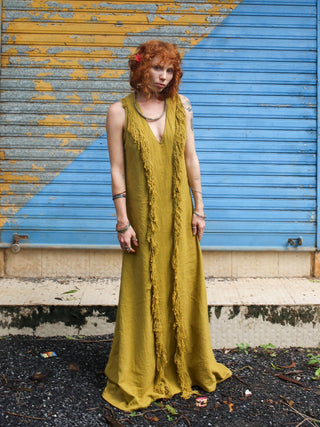 Kashi Maxi Dress in olive green khadi cotton, full-length front view against painted shutters
