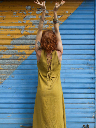 Laced back detail of the olive green Kashi Maxi Dress, model with arms raised