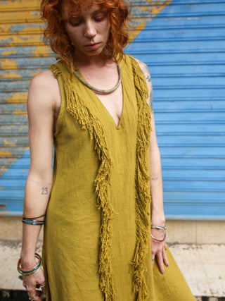 Close-up of the Kashi Maxi Dress olive green V-neck with cascading fringe trim