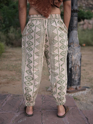 Back view of the Kathan unisex harem pants in beige cotton with all over olive green tribal print