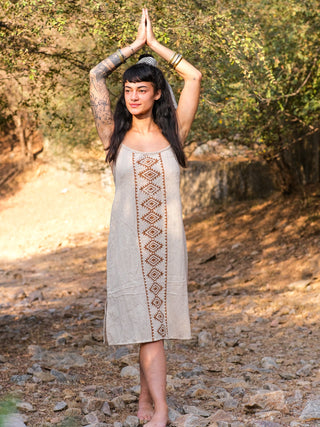 Model wearing the Lina Dress with arms raised, showing the free size A-line fall of the beige block print cotton dress