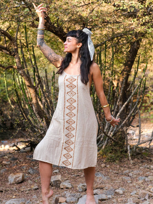 Side profile of the Lina Dress showing the rust hand block print panel on natural beige cotton for women